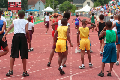 children cheer runners on at the starting line of a race